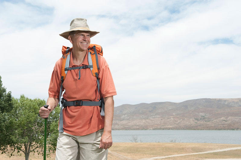 man hiking outside with lower back pain