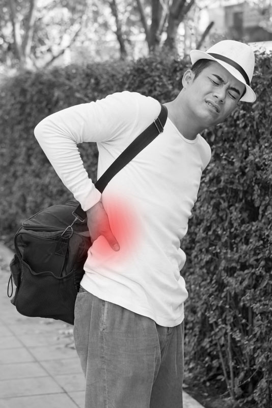 man wearing shoulder bags with lower back pain