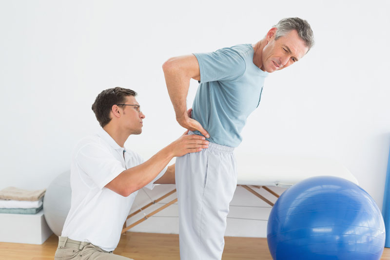 man receiving physiotherapy for lower back problem