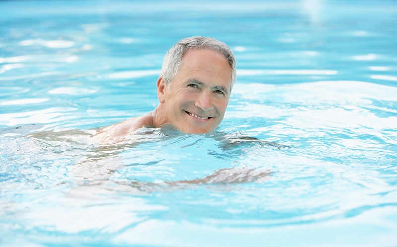 middle aged man using swimming as exercise in the pool