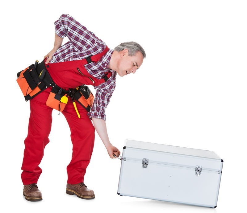 man bending down to pick up box with chronic lower back pain