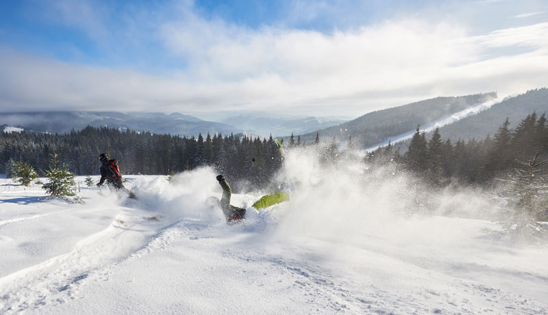 person crashing whilst skiing downhill