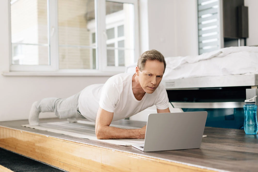 man doing front plank to help with his low back pain