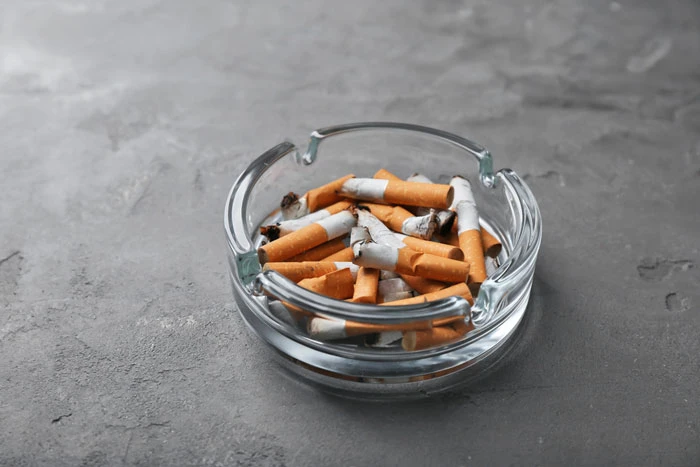 low back pain and a picture of an ashtray with cigarettes in it