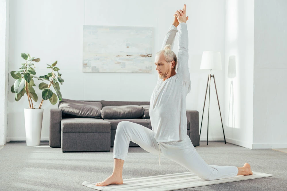 middle aged man stretching for his low back pain