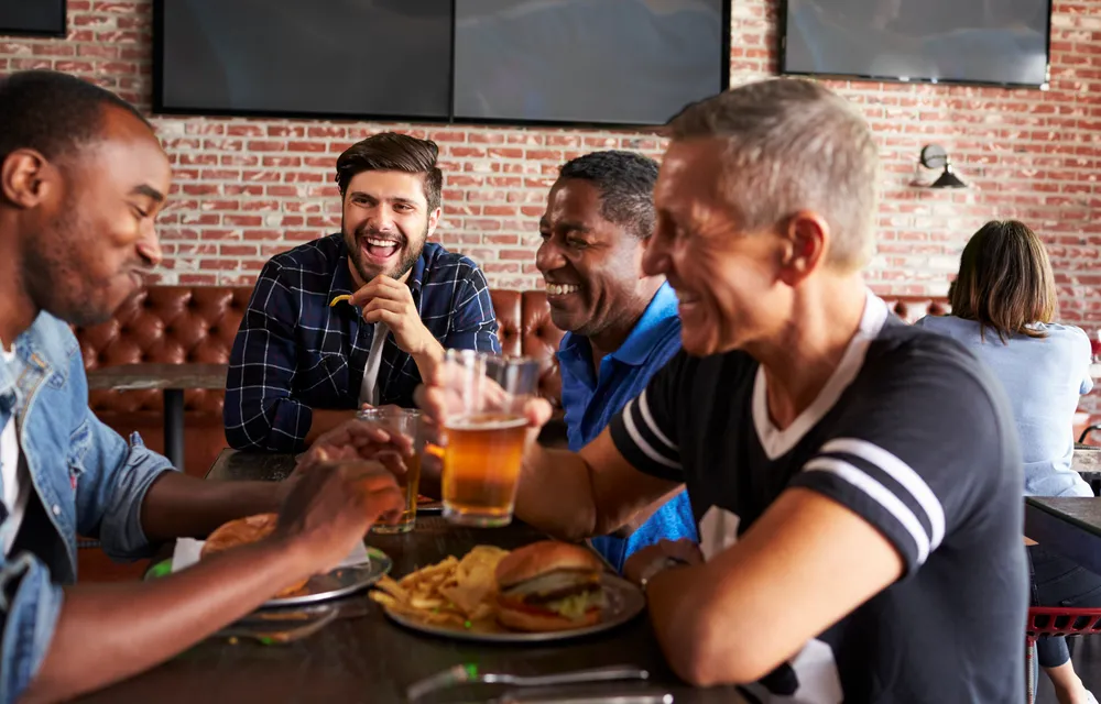 friends drinking at a bar chronic low back pain